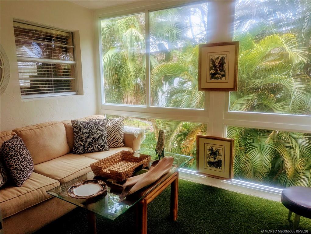 2950 Southeast Ocean Boulevard, Unit 56 Stuart, FL 34996 - Photo 7 of 12 a living room with furniture and a yard