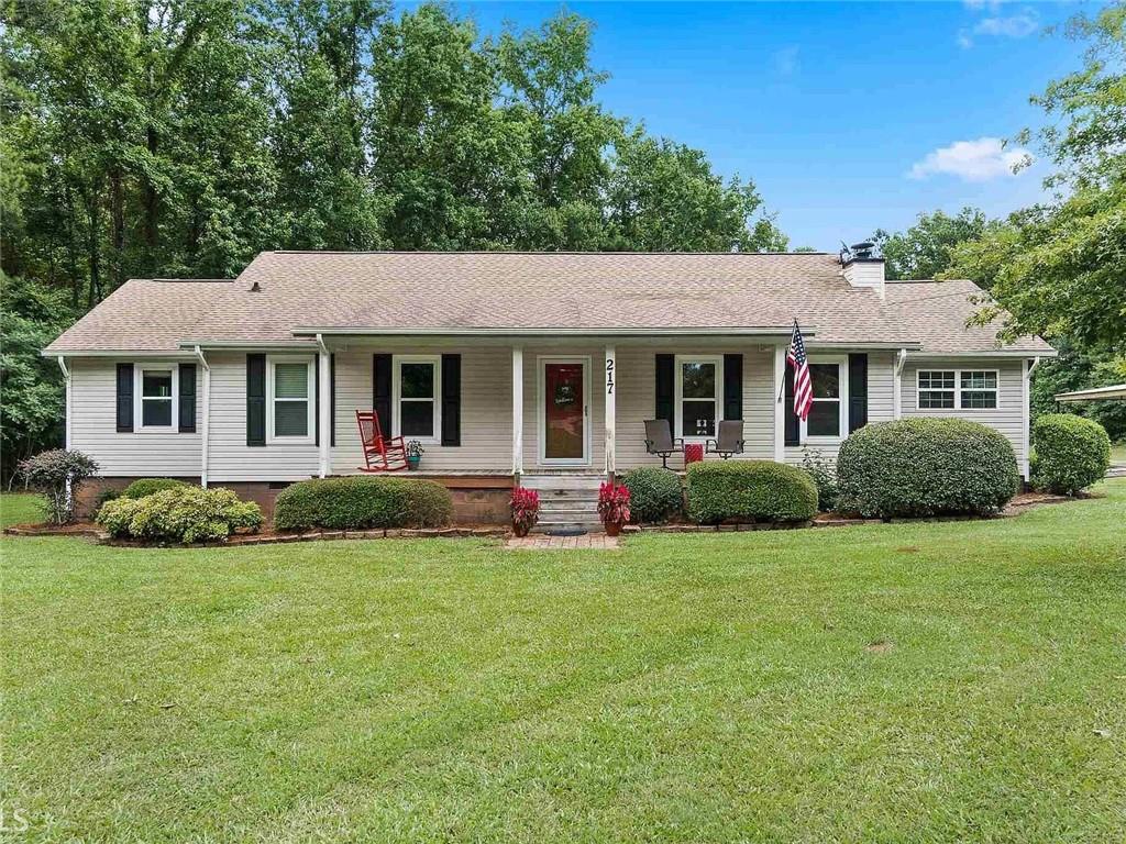 217 Babbs Mill Road Hampton, GA 30228 - Photo 1 of 39 a front view of a house with a garden