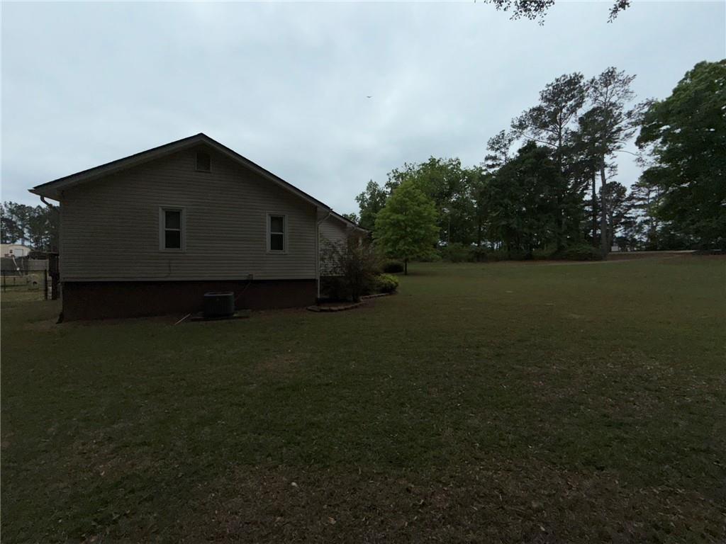 217 Babbs Mill Road Hampton, GA 30228 - Photo 13 of 39 a house with green field in front of it
