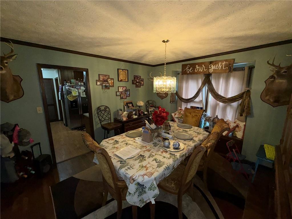 217 Babbs Mill Road Hampton, GA 30228 - Photo 17 of 39 a view of a dining room with furniture and chandelier