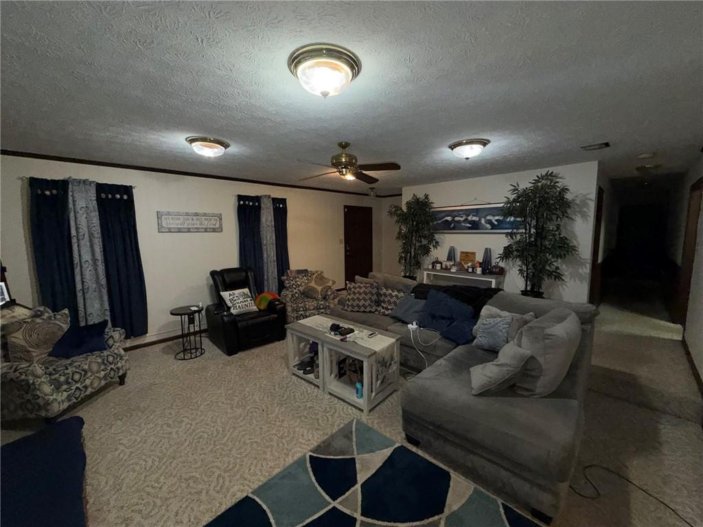 217 Babbs Mill Road Hampton, GA 30228 - Photo 3 of 39 a living room with furniture and a flat screen tv