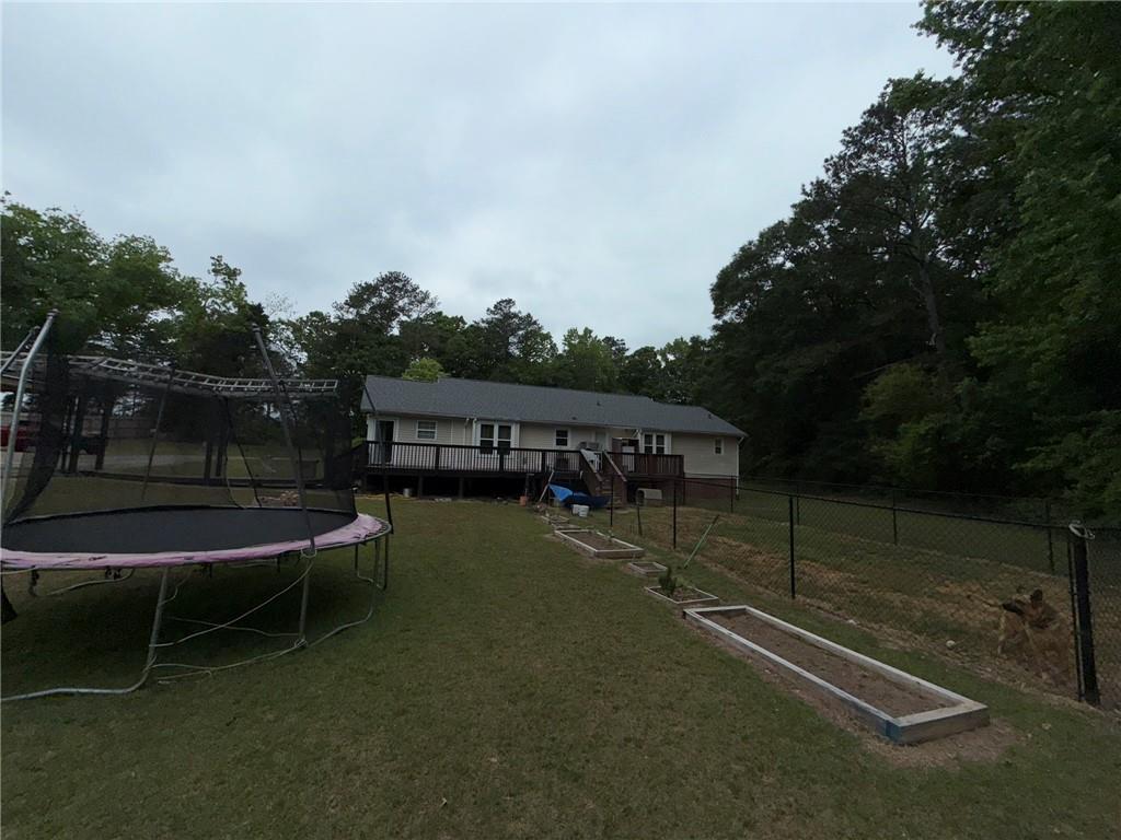 217 Babbs Mill Road Hampton, GA 30228 - Photo 34 of 39 a view of a wooden deck and a backyard