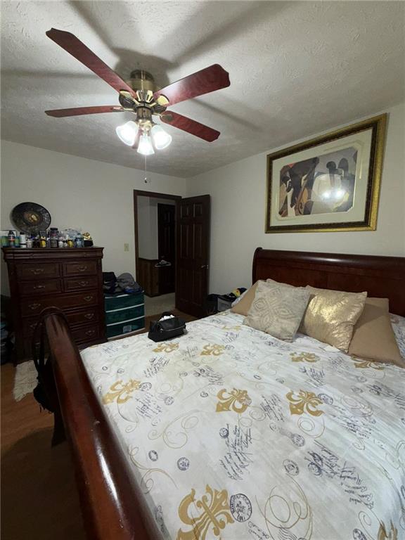 217 Babbs Mill Road Hampton, GA 30228 - Photo 5 of 39 a bedroom with a bed and a chandelier