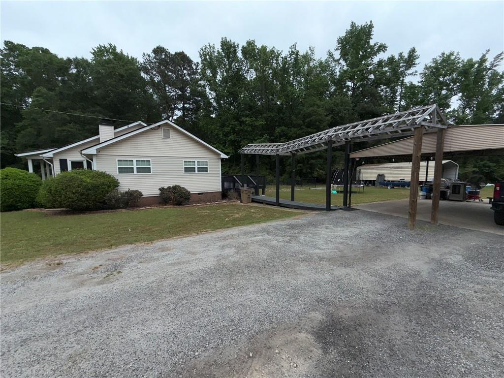 217 Babbs Mill Road Hampton, GA 30228 - Photo 8 of 39 a view of a house with a yard and large trees