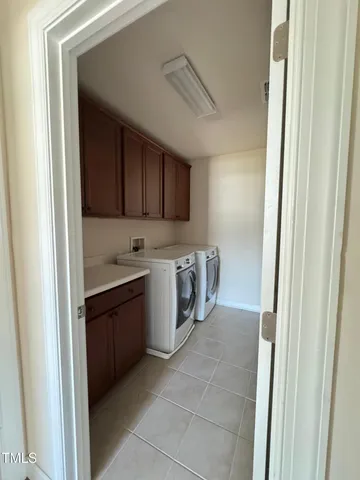 a kitchen with a refrigerator sink and cabinets