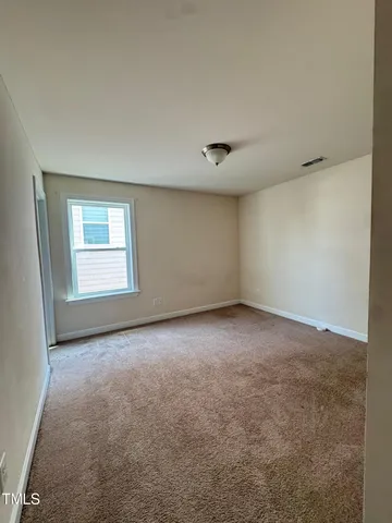 an empty room with a empty space and windows