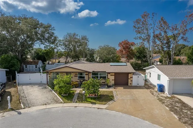a view of a house with a garden and pathway