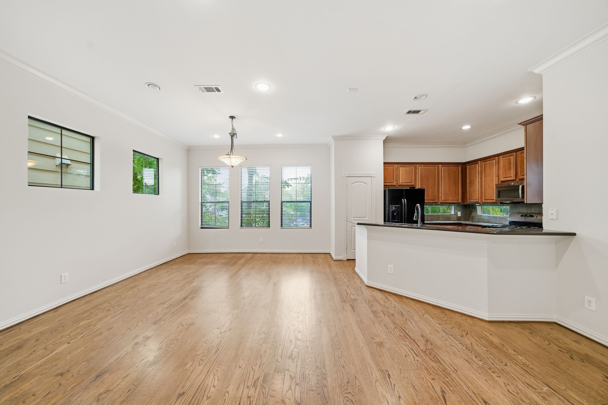 5310 Larkin Street, Unit B Houston, TX 77007 - Photo 13 of 36 a view of kitchen with kitchen island wooden floor and window