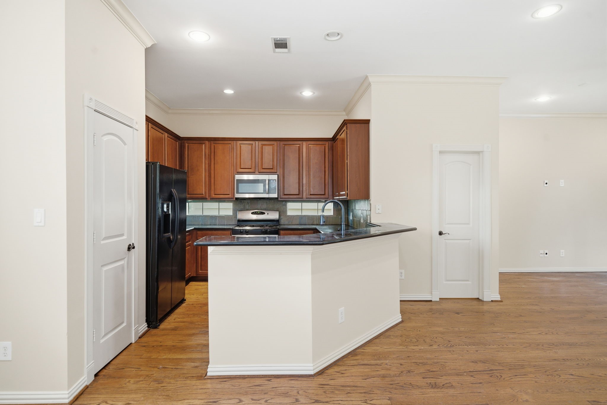 5310 Larkin Street, Unit B Houston, TX 77007 - Photo 14 of 36 a kitchen with stainless steel appliances granite countertop a refrigerator and a stove top oven
