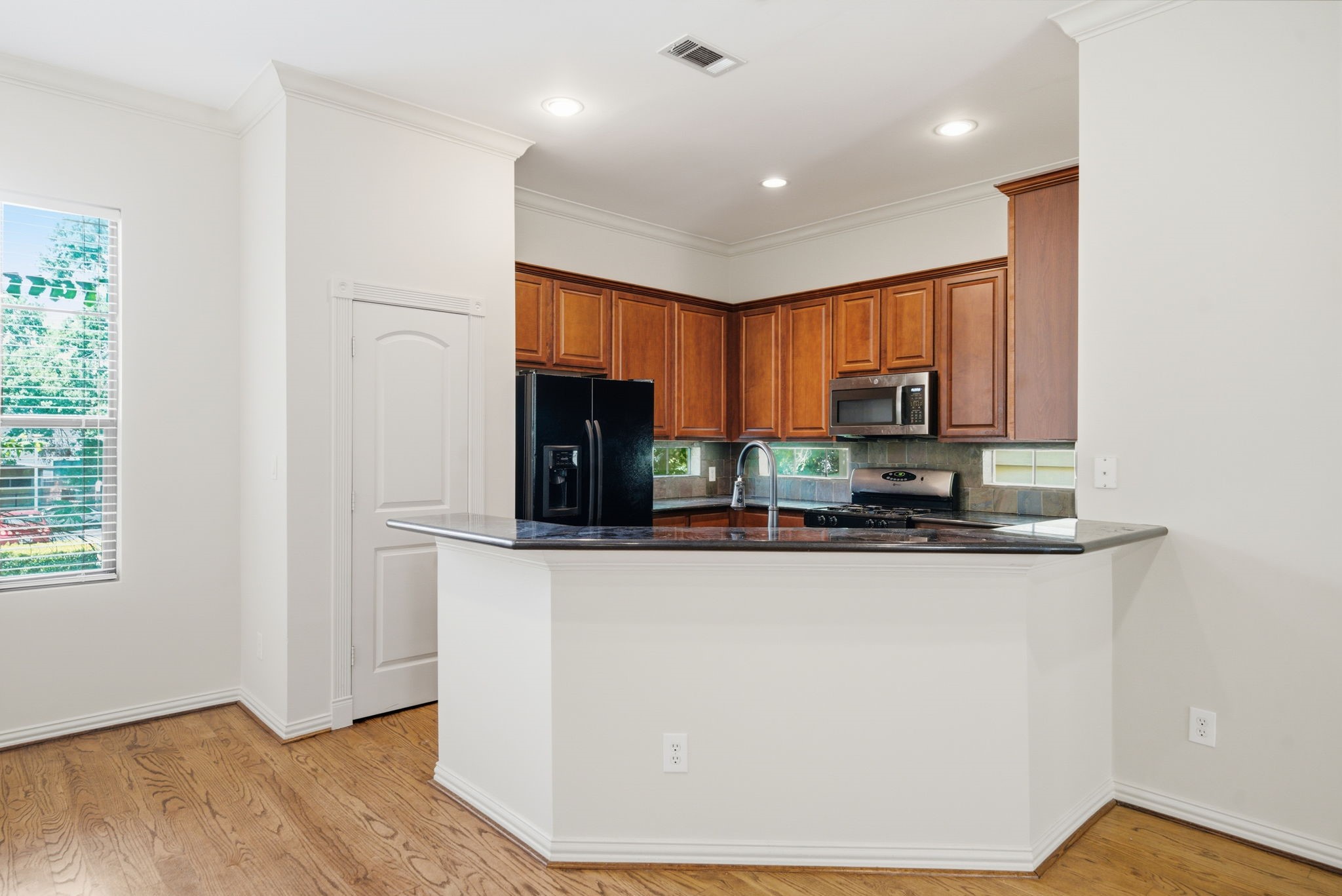 5310 Larkin Street, Unit B Houston, TX 77007 - Photo 15 of 36 a kitchen with stainless steel appliances granite countertop a refrigerator a stove a sink and a microwave