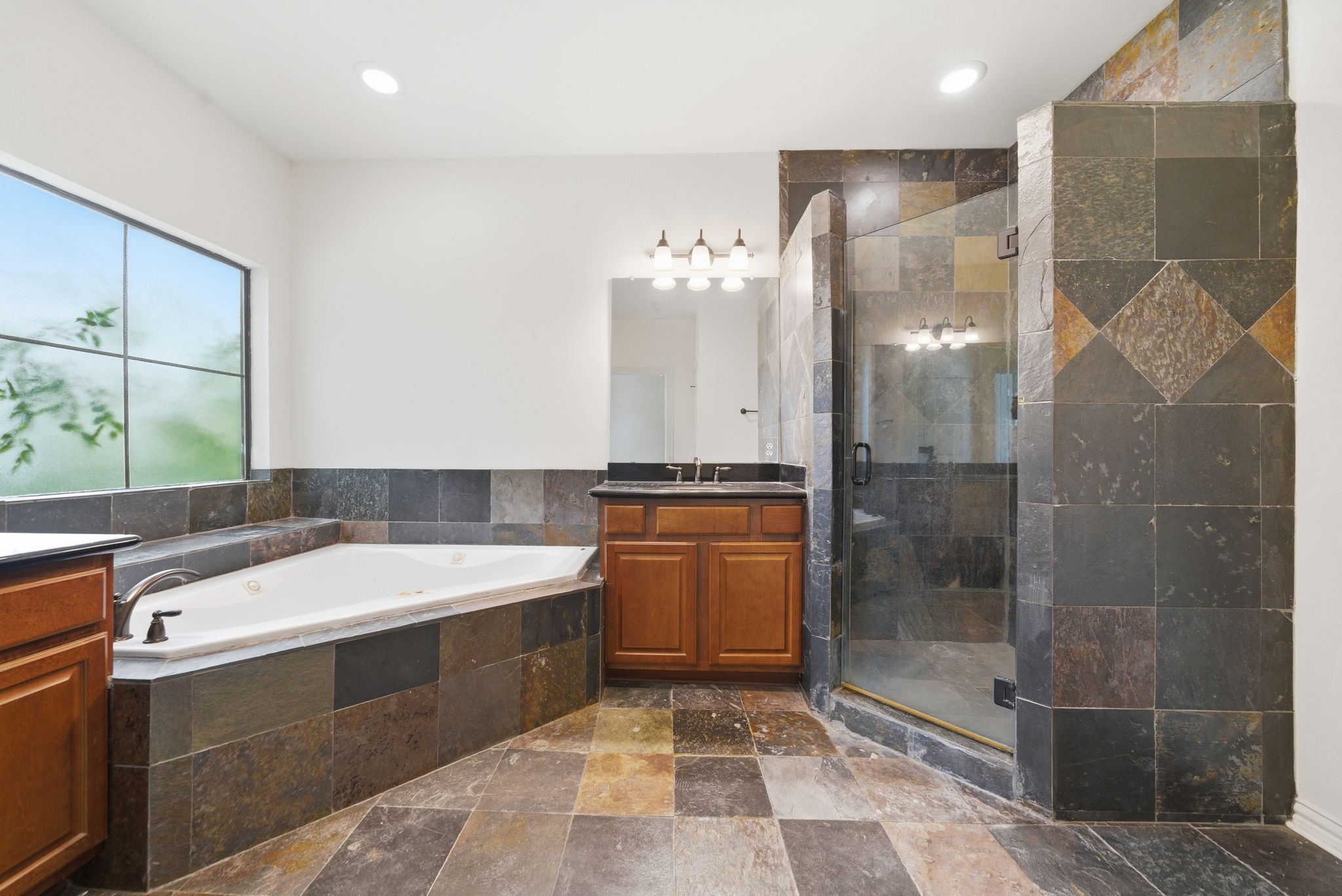 5310 Larkin Street, Unit B Houston, TX 77007 - Photo 28 of 36 a bathroom with a tub sink mirror and shower