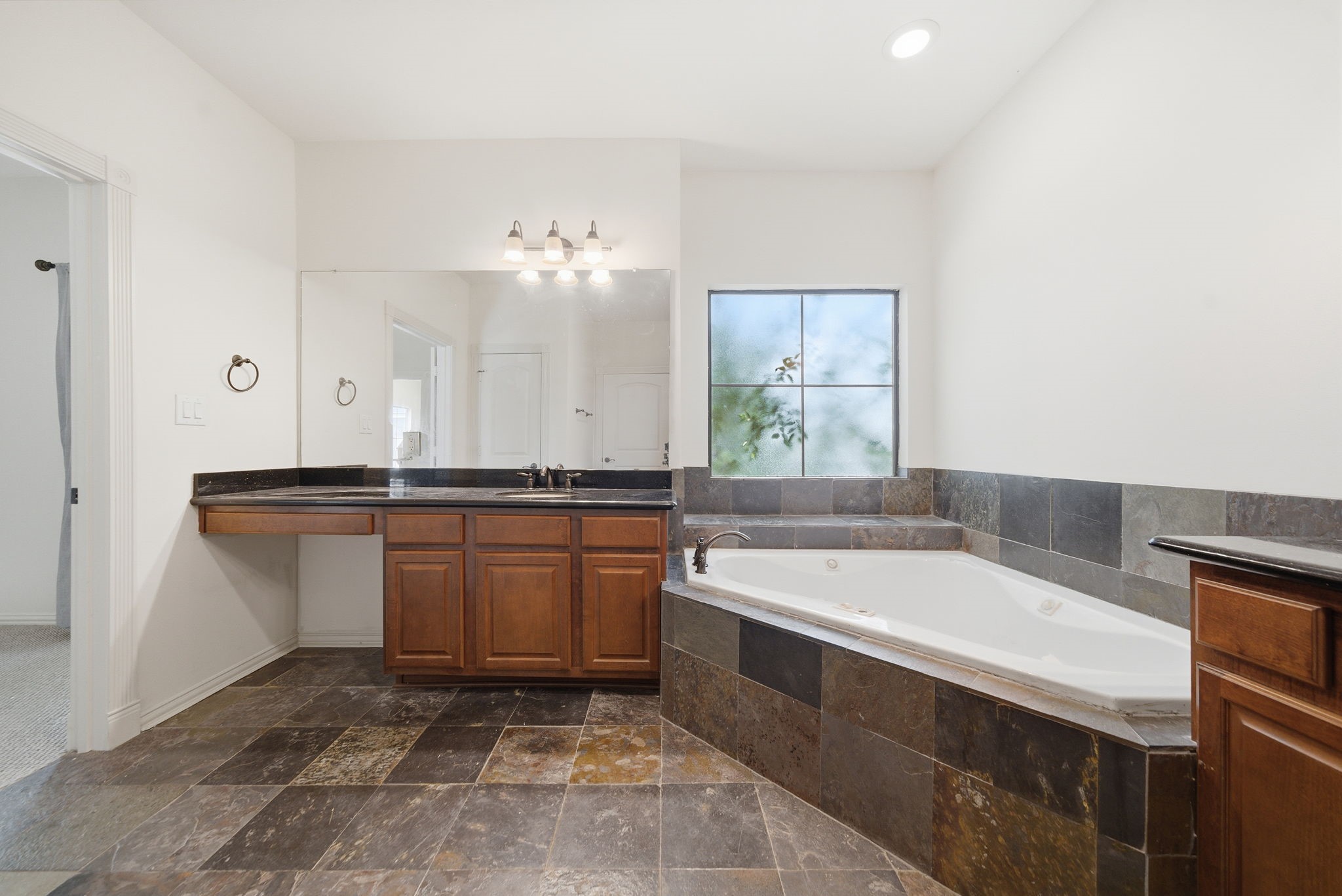 5310 Larkin Street, Unit B Houston, TX 77007 - Photo 29 of 36 a bathroom with a bathtub sink and mirror