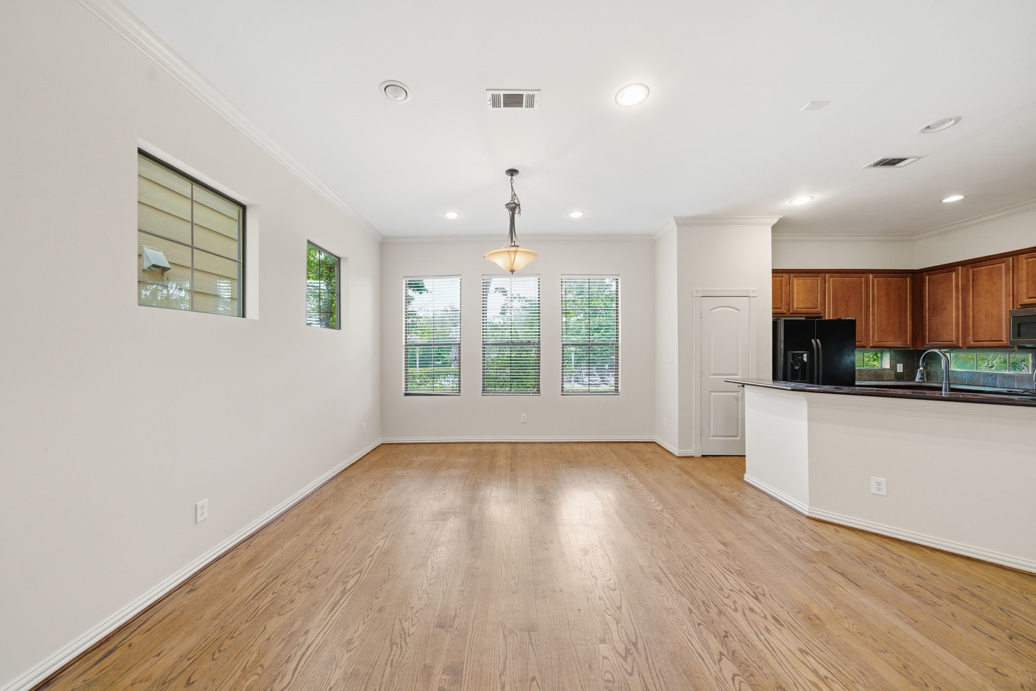 5310 Larkin Street, Unit B Houston, TX 77007 - Photo 10 of 36 wooden floor in an empty room with a window