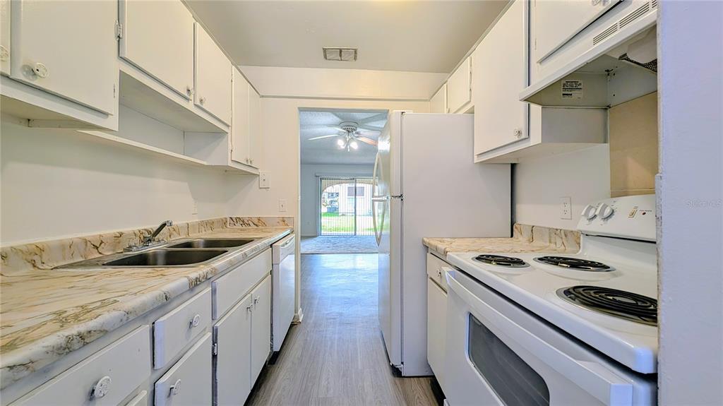 5957 Casa Del Rey Circle, Unit A Orlando, FL 32809 - Photo 3 of 6 a kitchen with stainless steel appliances granite countertop a stove and a sink