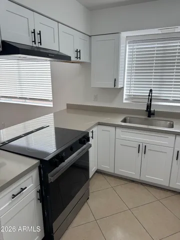 a kitchen with a sink and cabinets