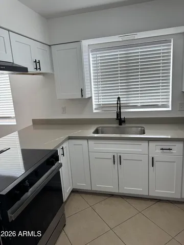 a kitchen with a sink and cabinets