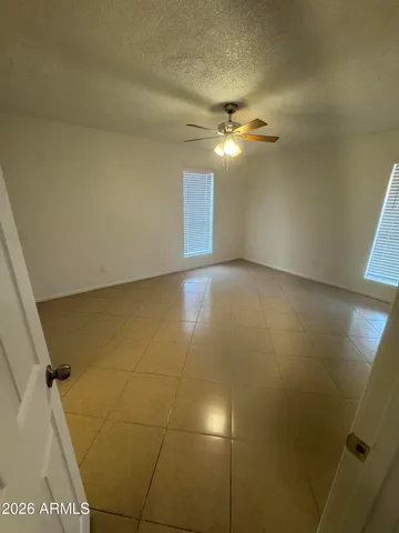 an empty room with a empty space and a ceiling fan