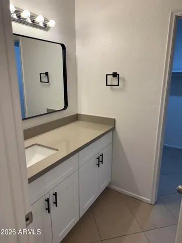 a bathroom with a mirror sink and vanity