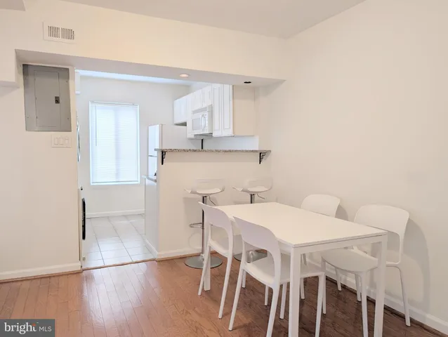 a view of a dining room with furniture and wooden floor