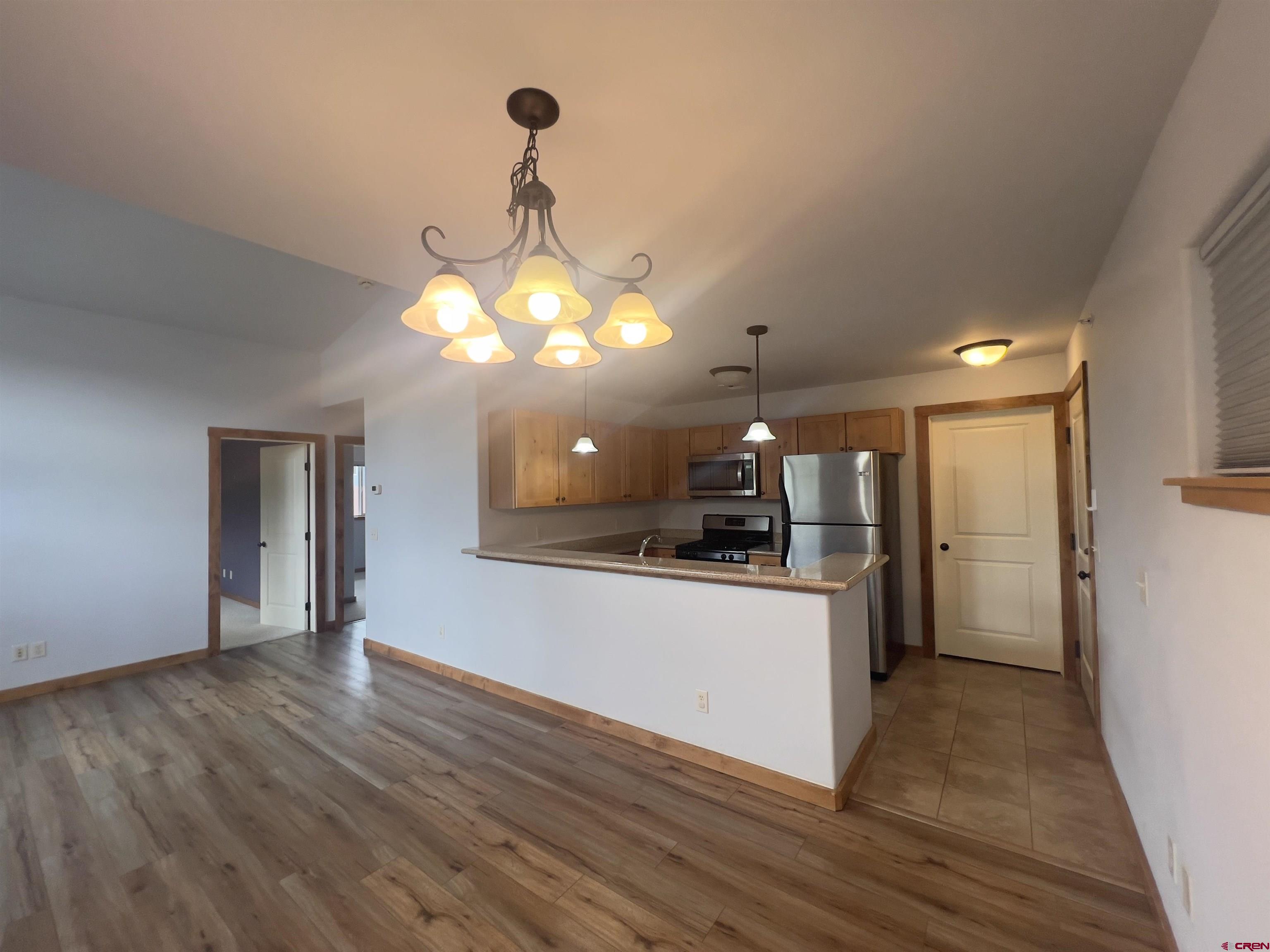540 Redcliff Circle, Unit E 203 Ridgway, CO 81432 - Photo 11 of 36 a kitchen with stainless steel appliances granite countertop wooden floors and granite counter tops