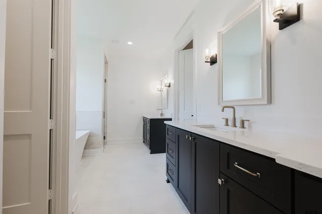 a bathroom with a double vanity sink a toilet and a mirror