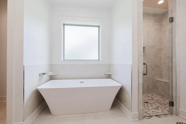 a bathroom with a bathtub and shower