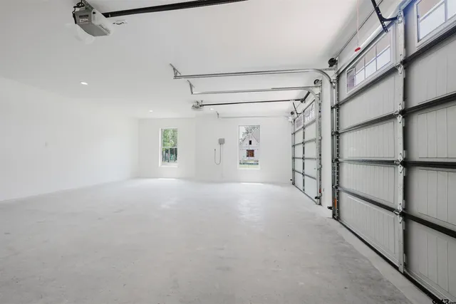 a view of a bedroom with a ceiling fan and a window