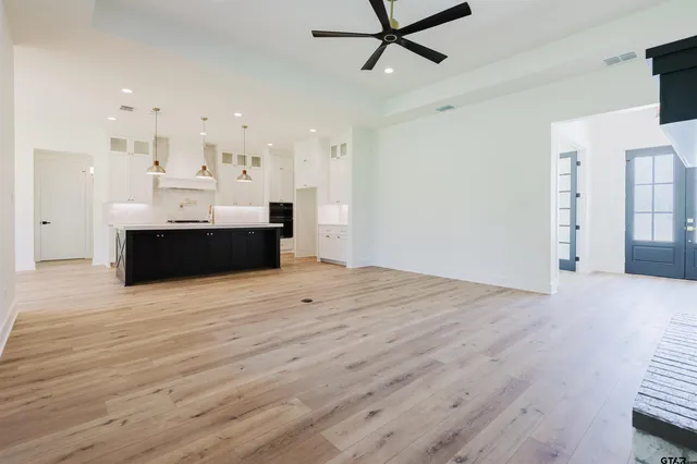a view of kitchen and kitchen island hardwood floor