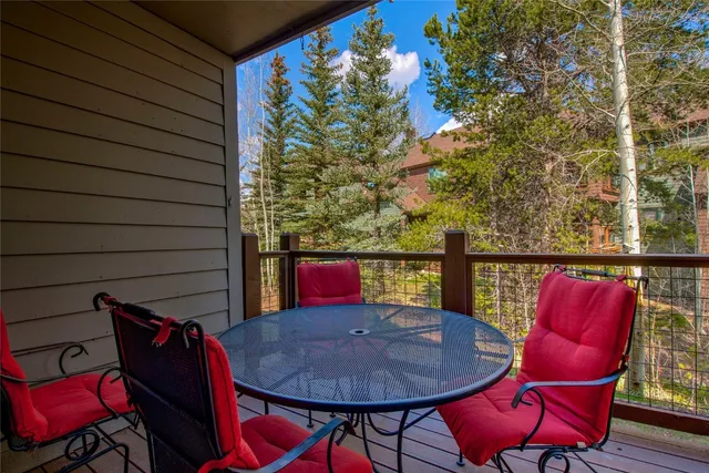 a balcony with table and chairs