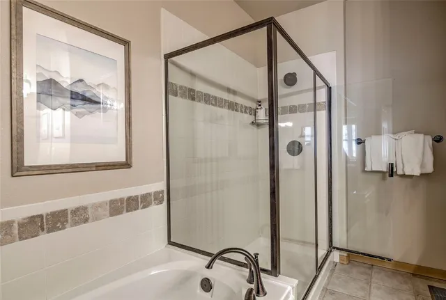 a bathroom with a bathtub and a shower