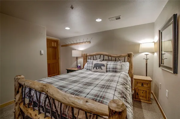 a bedroom with a bed and a table