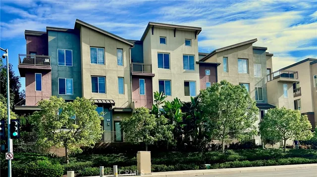 a front view of a house with plants