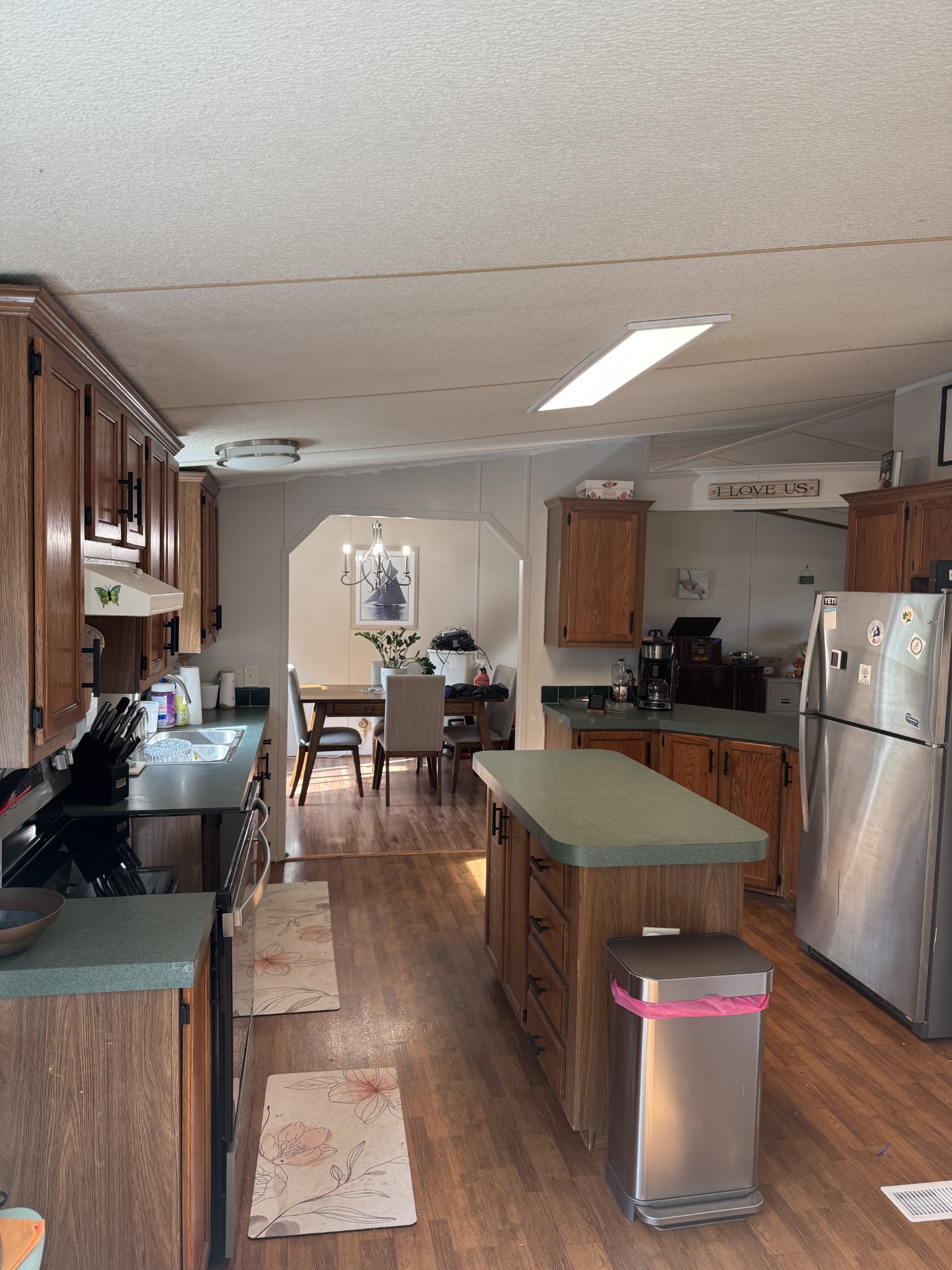 1195 Leo Baker Road Ashland City, TN 37015 - Photo 2 of 7 a kitchen with stainless steel appliances granite countertop a refrigerator a stove a sink a dining table and chairs with wooden floor