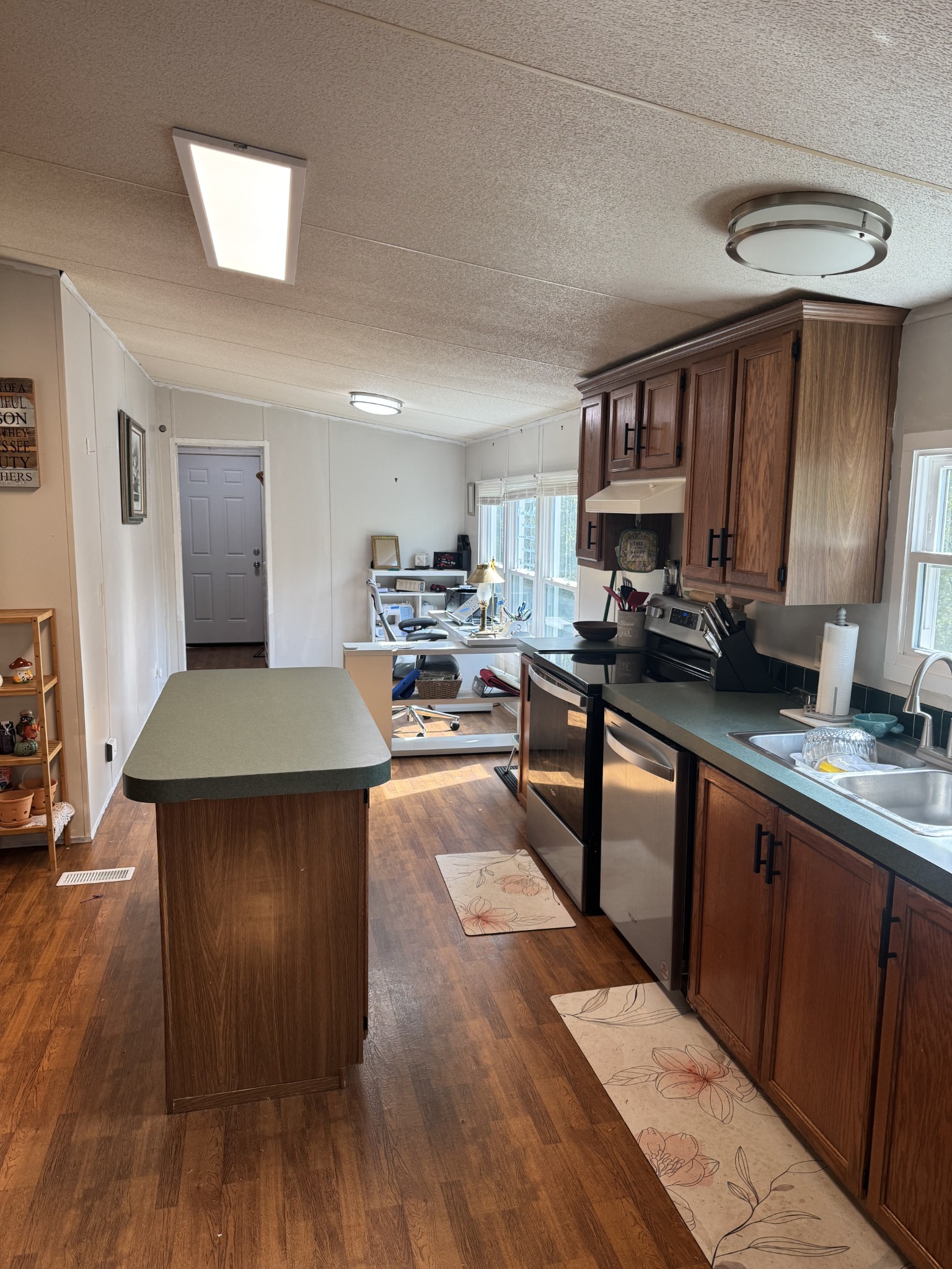 1195 Leo Baker Road Ashland City, TN 37015 - Photo 3 of 7 a kitchen with stainless steel appliances granite countertop a stove top oven a sink dishwasher and cabinets with wooden floor