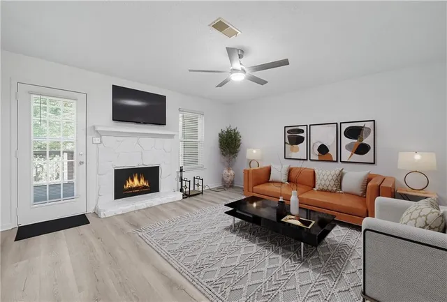 a living room with furniture fireplace and a flat screen tv