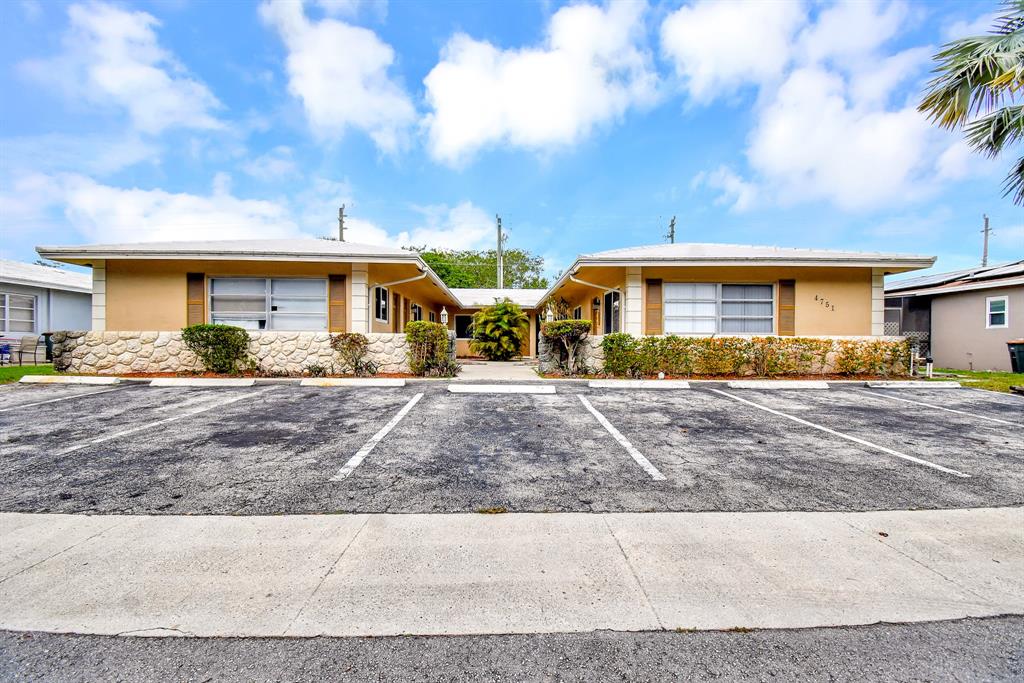 4751 Northeast 21st Terrace, Unit 4 Lighthouse Point, FL 33064 - Photo 1 of 22 a front view of a house with garden