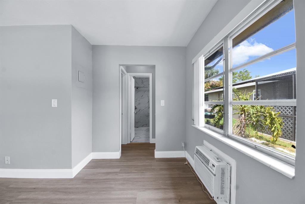 4751 Northeast 21st Terrace, Unit 4 Lighthouse Point, FL 33064 - Photo 12 of 22 wooden floor in an empty room with a window