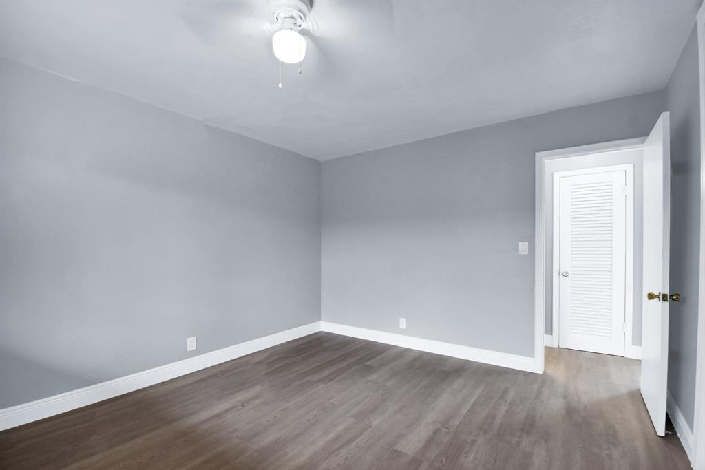4751 Northeast 21st Terrace, Unit 4 Lighthouse Point, FL 33064 - Photo 15 of 22 a view of wooden floor and windows in a room