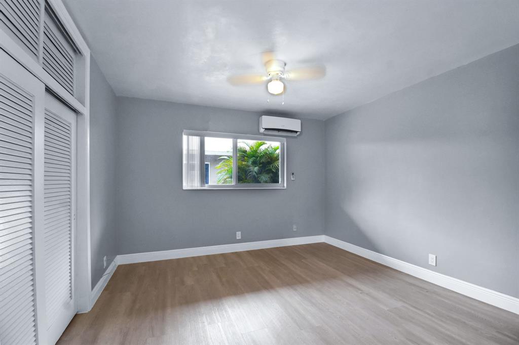 4751 Northeast 21st Terrace, Unit 4 Lighthouse Point, FL 33064 - Photo 17 of 22 wooden floor in an empty room with a window