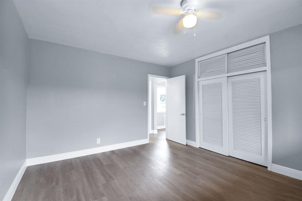 4751 Northeast 21st Terrace, Unit 4 Lighthouse Point, FL 33064 - Photo 19 of 22 a view of an empty room with wooden floor and a window