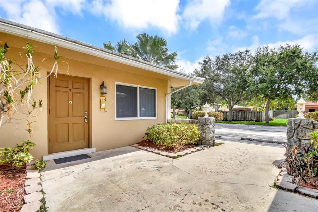 4751 Northeast 21st Terrace, Unit 4 Lighthouse Point, FL 33064 - Photo 3 of 22 a view of a house with a yard and plants