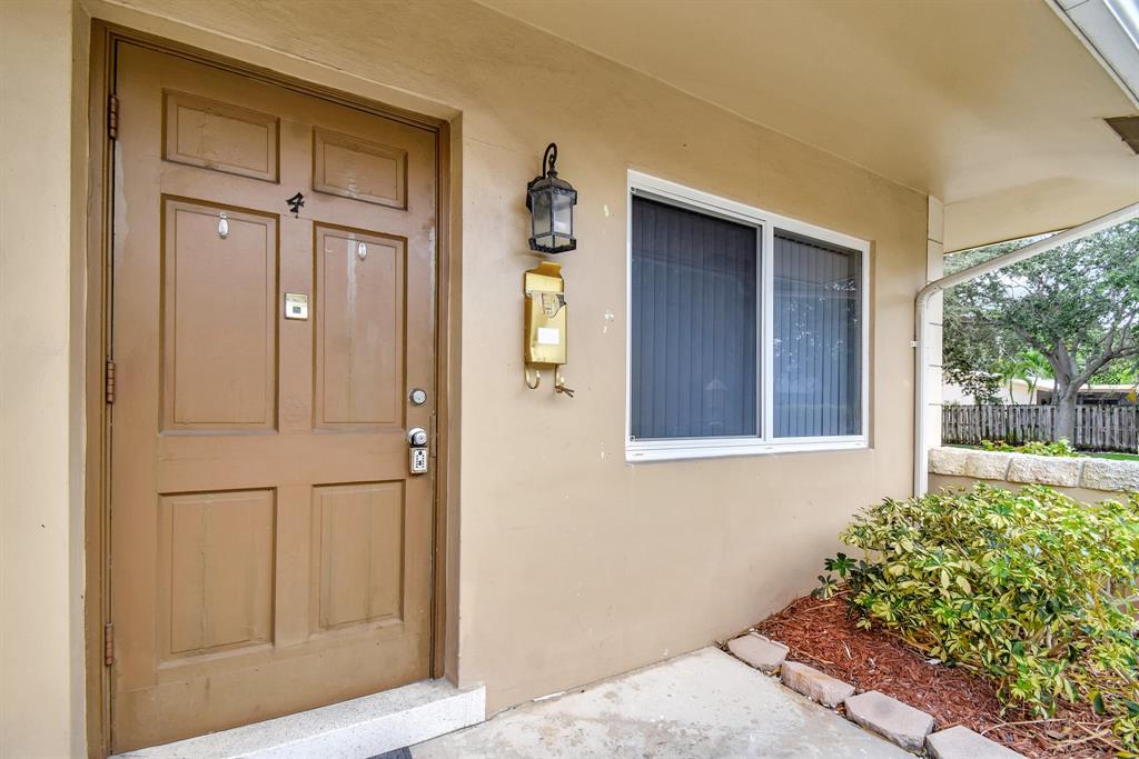 4751 Northeast 21st Terrace, Unit 4 Lighthouse Point, FL 33064 - Photo 4 of 22 front view of a house with a door