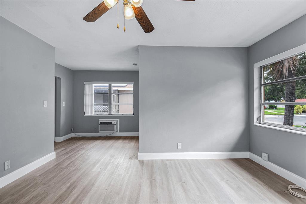 4751 Northeast 21st Terrace, Unit 4 Lighthouse Point, FL 33064 - Photo 6 of 22 wooden floor in an empty room with a window