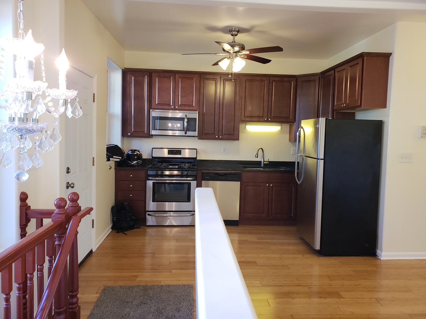 54 East 50th Street, Unit 1 Chicago, IL 60615 - Photo 13 of 27 a kitchen with stainless steel appliances granite countertop a refrigerator a sink dishwasher a stove with wooden cabinets and floor