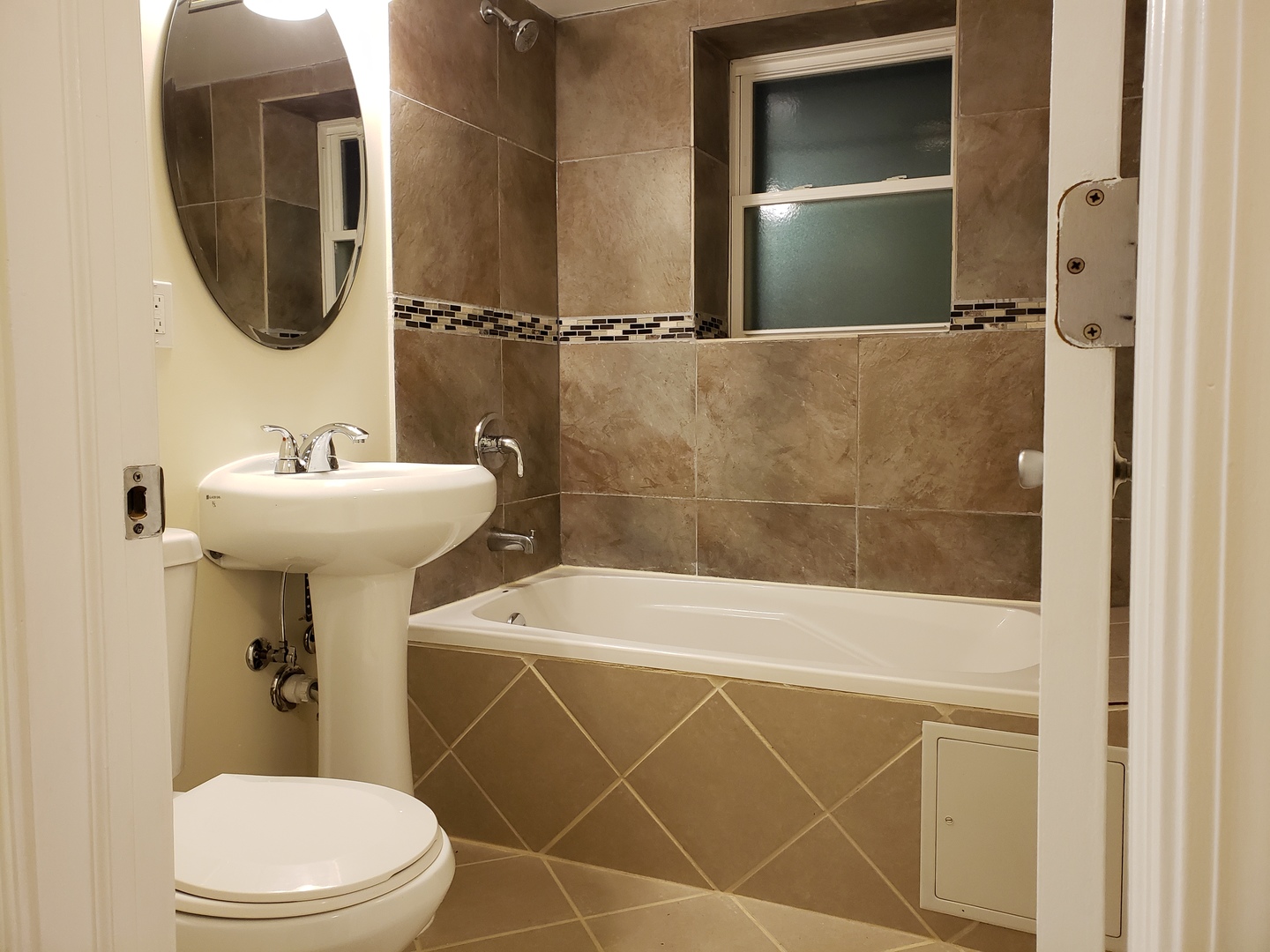 54 East 50th Street, Unit 1 Chicago, IL 60615 - Photo 19 of 27 a bathroom with a sink a toilet and shower