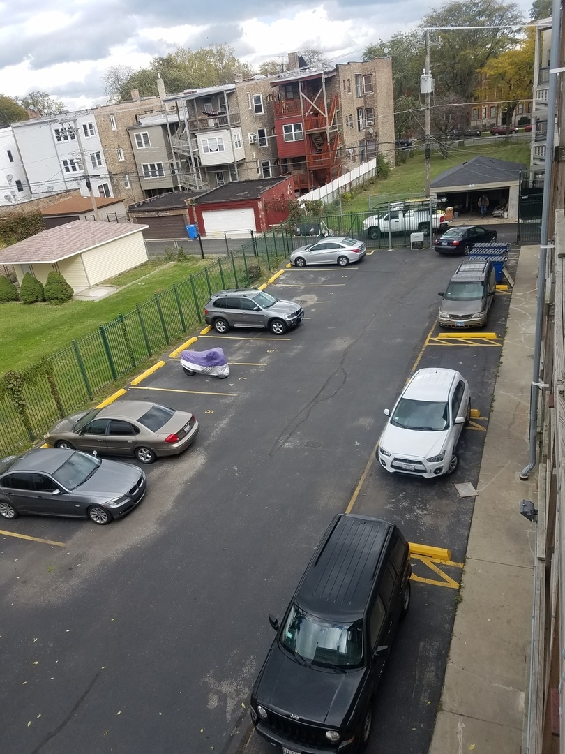 54 East 50th Street, Unit 1 Chicago, IL 60615 - Photo 26 of 27 a view of a city street with couple of cars parked in parking lot