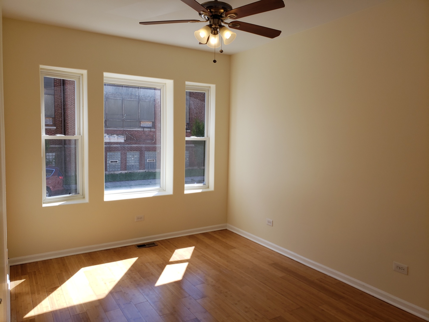 54 East 50th Street, Unit 1 Chicago, IL 60615 - Photo 6 of 27 an empty room with wooden floor closet and windows