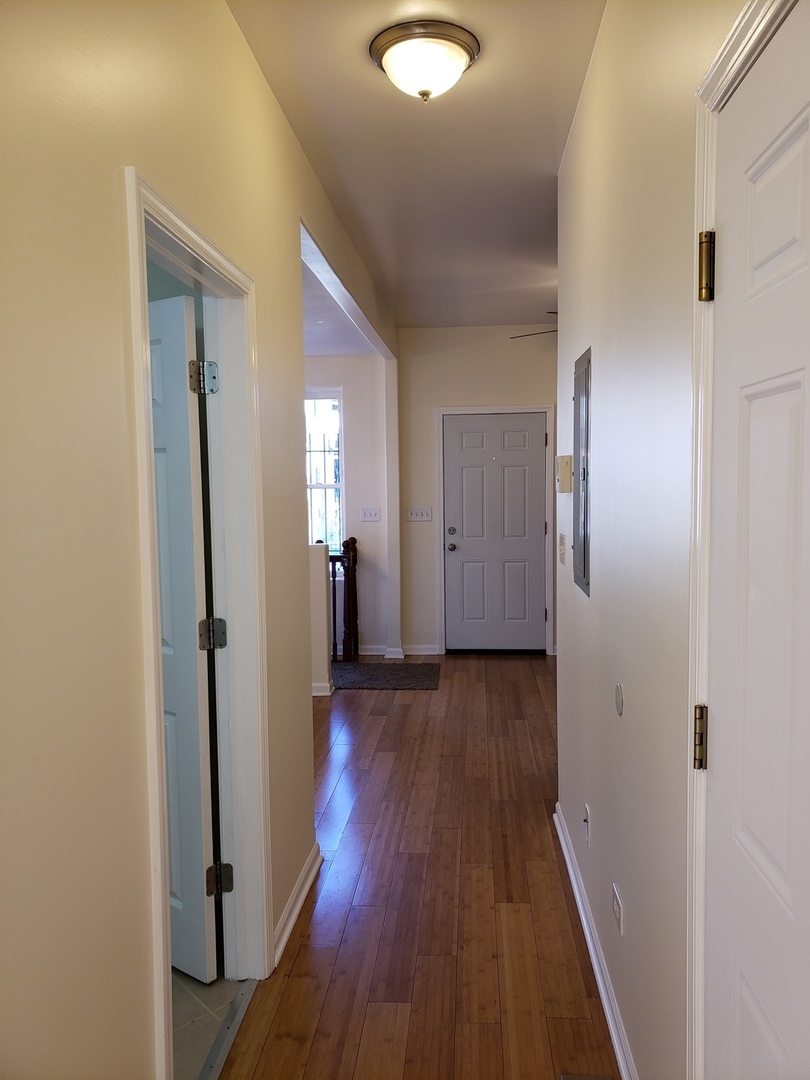 54 East 50th Street, Unit 1 Chicago, IL 60615 - Photo 8 of 27 a view of a hallway with wooden floor