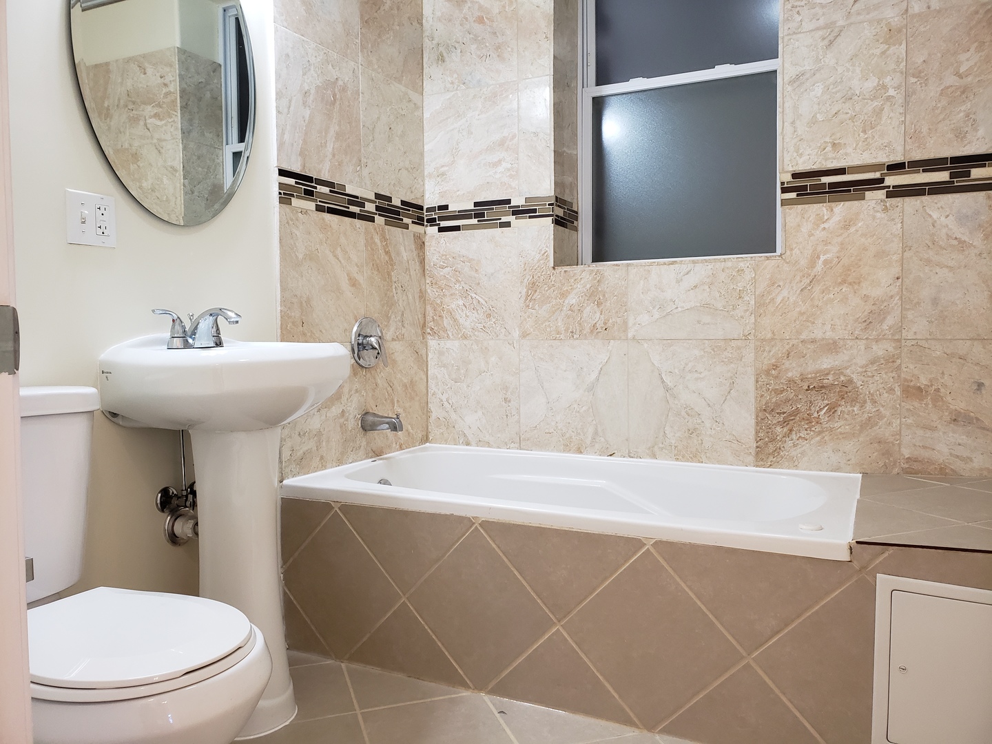 54 East 50th Street, Unit 1 Chicago, IL 60615 - Photo 9 of 27 a bathroom with a sink a toilet and a mirror