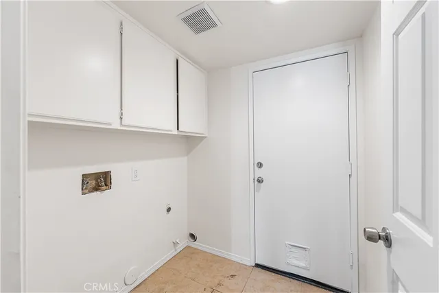 a view of a room that has a sink and cabinets